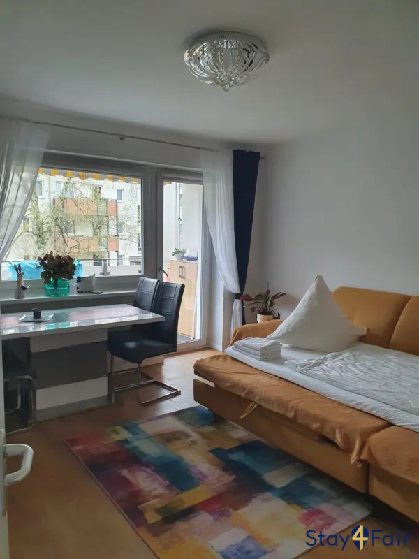 clean living room with sofa bed in apartment Hannover tram line 6