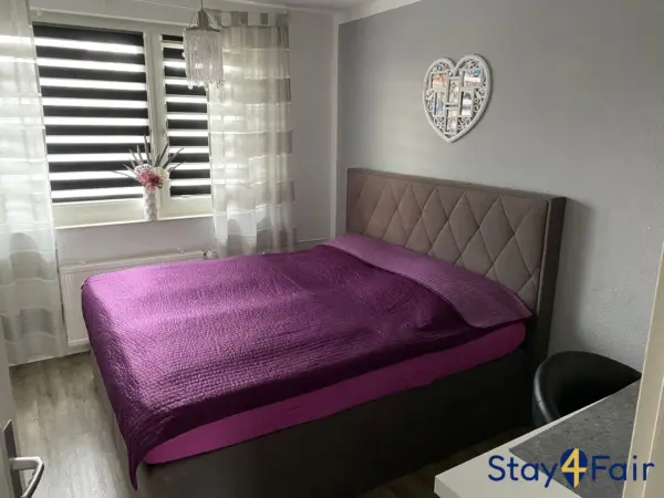 bedroom with large double bed in apartment near Hannover exhibition center