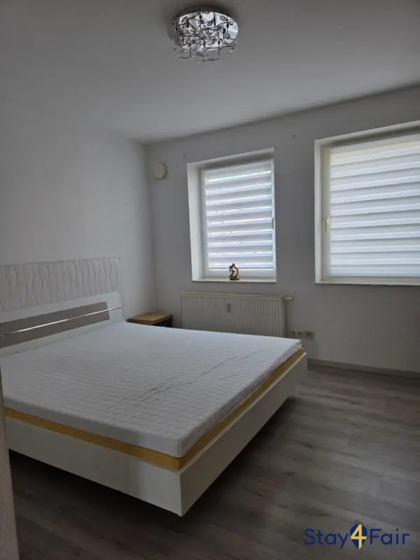 bedroom with large double bed in apartment near Hannover exhibition center