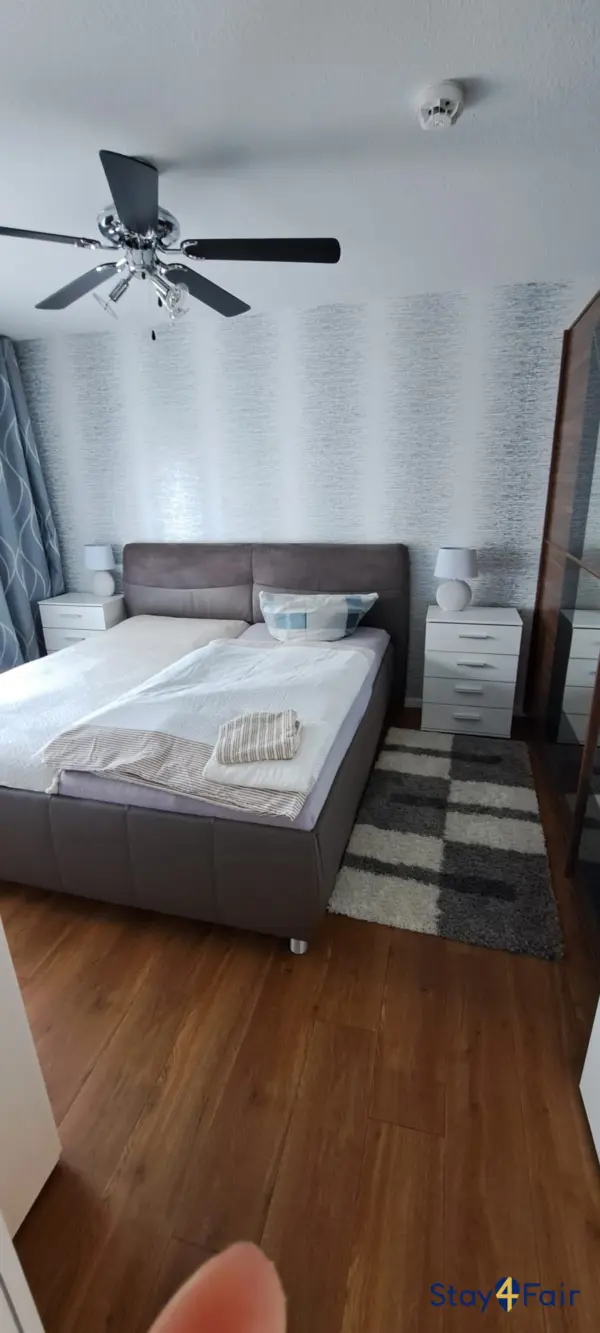 bedroom with large double bed in apartment near Hannover exhibition center